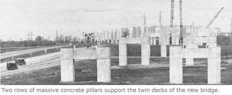 Two rows of massive concrete pillars support the twin decks of the new bridge.