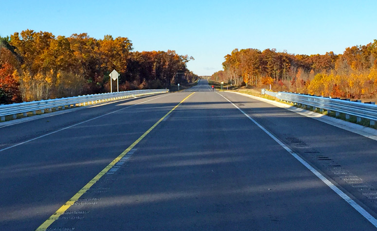 On the M-231 Grand River bridge facing southerly.