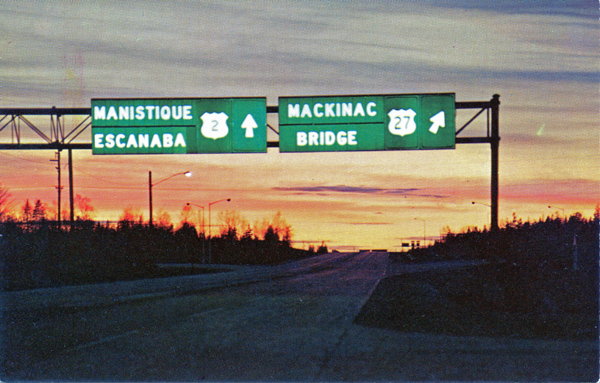 Highway signs for US-2 and US-27 on the north end of the Mackinac Bridge in 1957.